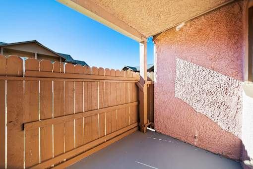 A brown fence is on the left side of the image.