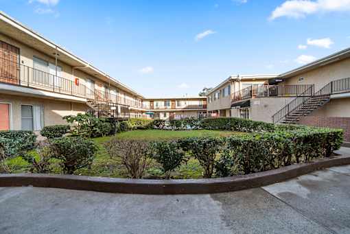 A sunny day at a residential complex with a clear blue sky.