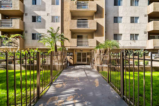 A concrete building with a gate in front of it.