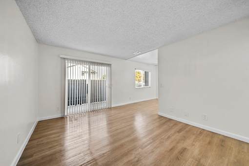 A room with wooden floors and white walls.