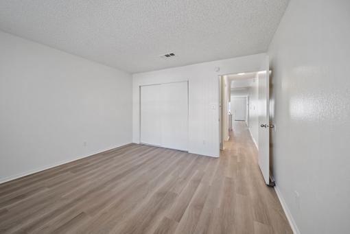 A room with a white door and a white wall.