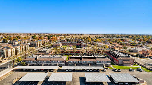 A bird flies over a residential area with apartment buildings.