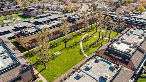 A bird's eye view of a residential area with houses and trees.