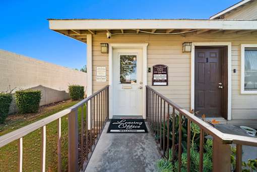 A house with a white door and a sign that says "Loving Wife".