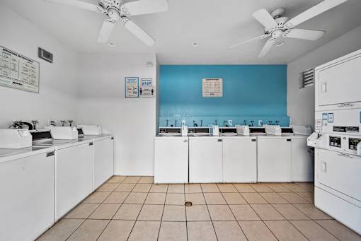A laundry room with washers and dryers.