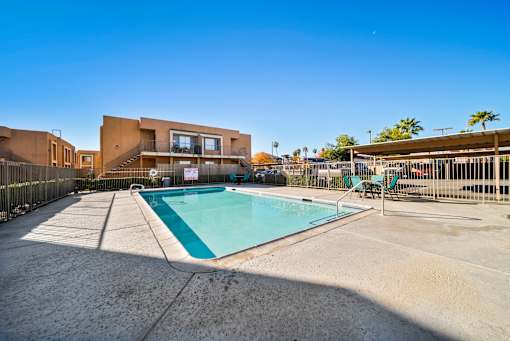 A swimming pool in front of a modern building.