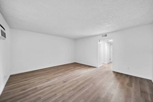 A room with wooden flooring and a white ceiling.