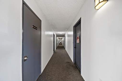 A long hallway with doors on both sides.