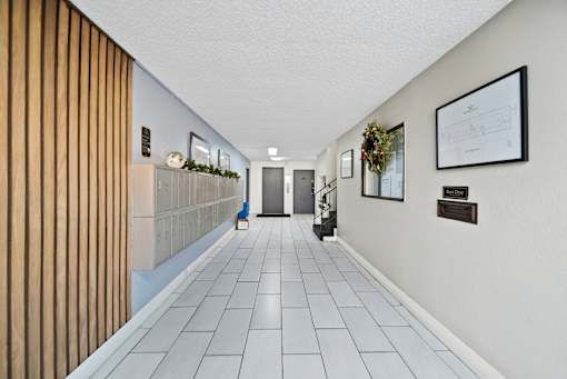 A long hallway with a wreath on the wall.