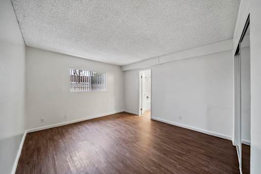 A room with a wooden floor and white walls.