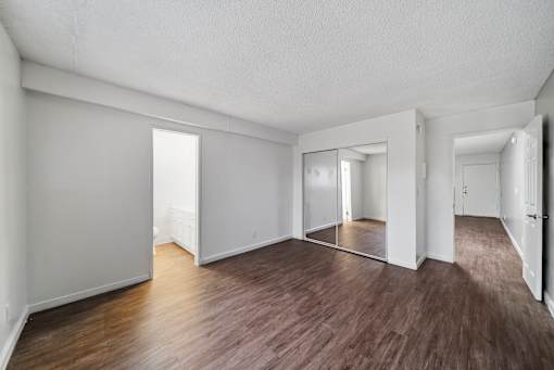 A room with wooden floors and white walls.