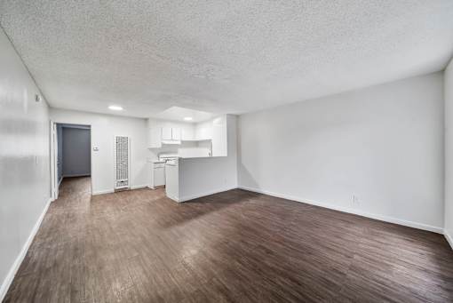 A room with a wooden floor and white walls.