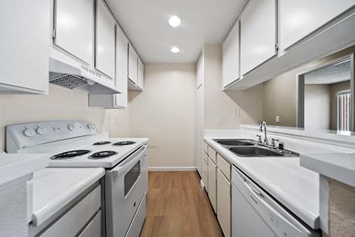 A modern kitchen with white appliances and cabinets.