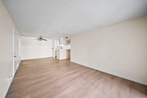 A room with a ceiling fan and light fixture.