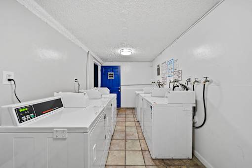 A row of washing machines in a laundromat.