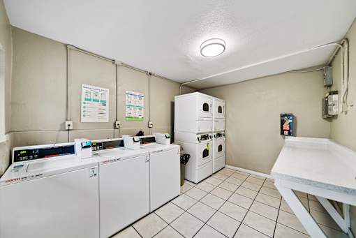 A clean, white-walled room with a white table and a white oven.
