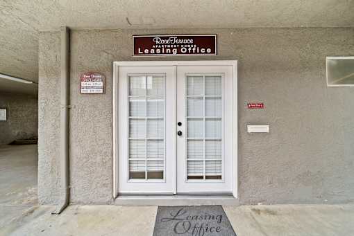 The front door of a building with a sign that says Leasing Office.