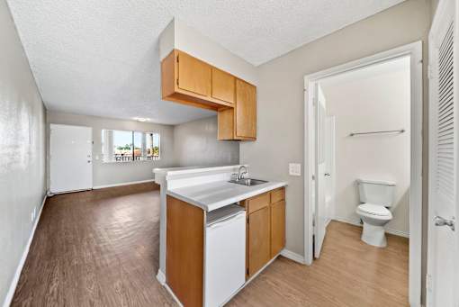 A kitchen with white appliances and wooden cabinets.