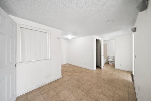 A room with white walls and a tiled floor.