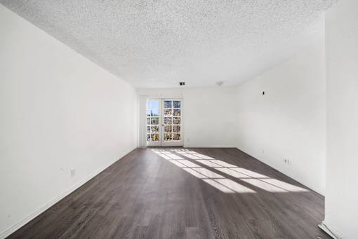 A room with wooden floors and white walls.