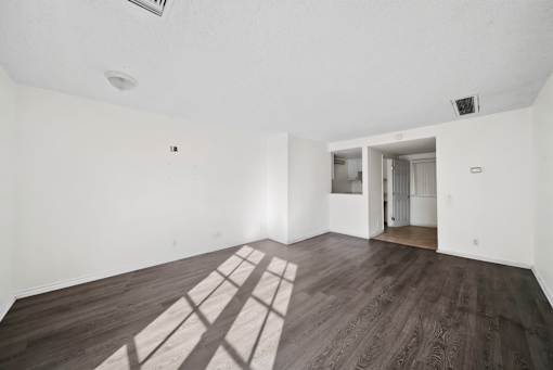 A room with wooden floors and white walls.