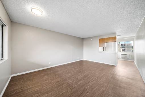 A room with wooden flooring and a single light on the ceiling.