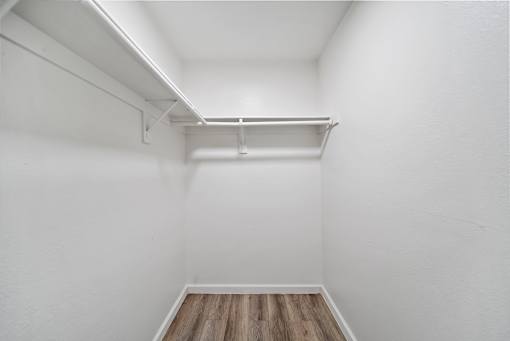 A white room with a wooden floor and a white ceiling.