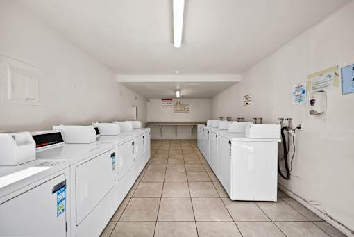 A laundromat with rows of washers and dryers.