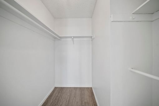 A white room with a wooden floor and white walls.