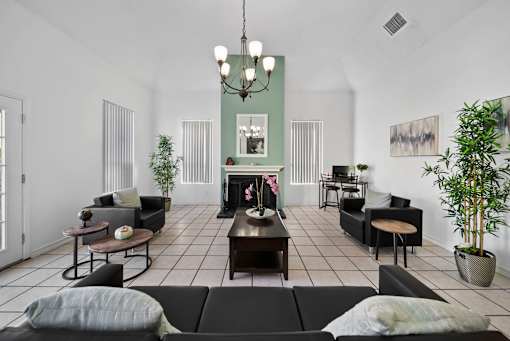 A living room with a fireplace and a chandelier.