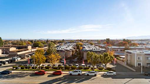 A parking lot with cars and a building in the background.