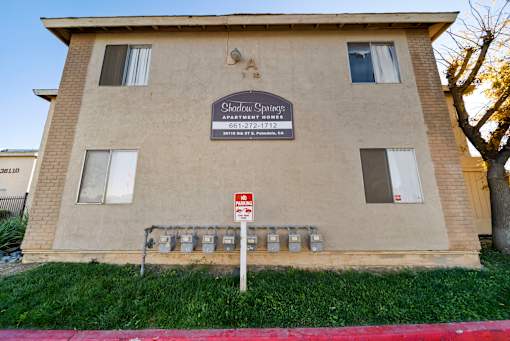 A building with a sign that says "Shadow Spurge" on it.
