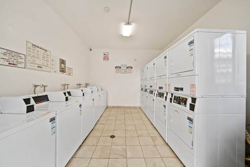 A row of washing machines in a laundromat.