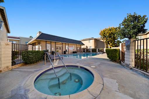 A hot tub sits in the middle of a patio.