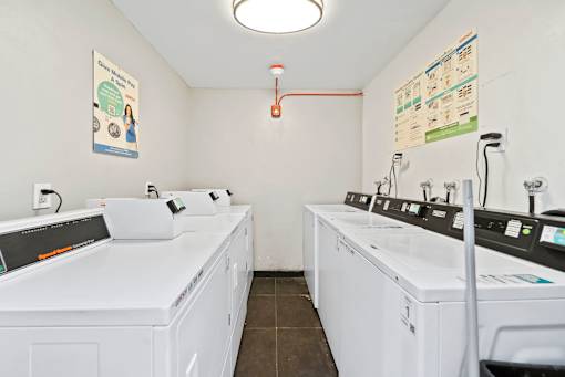A laundromat with white washers and dryers.
