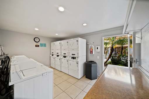 A laundry room with washers and dryers.