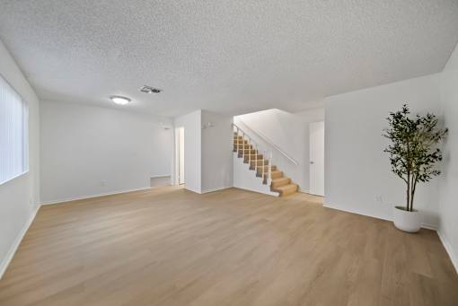 A room with wooden floors and a staircase.