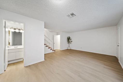 A room with wooden floors and white walls.