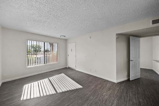 A room with a window and a door.