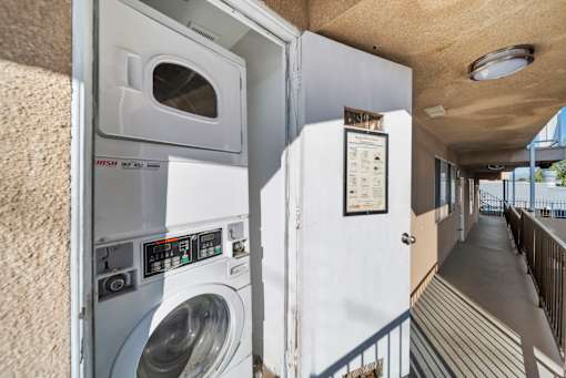 A washing machine is installed in a small room.