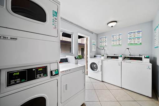 A row of washing machines in a laundromat.