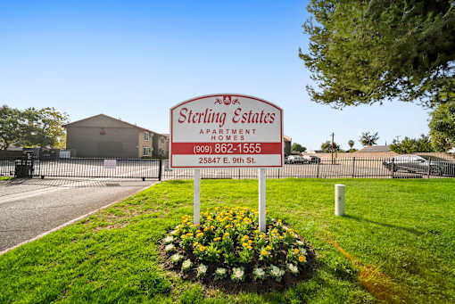 A Sterling Estates Apartments sign is in front of a building.
