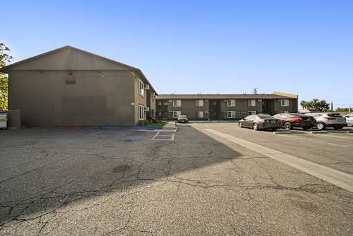 A parking lot with a building in the background.