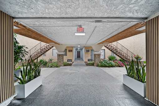 A long hallway with a staircase on both sides.