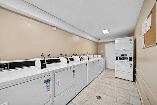 A row of washing machines in a laundry room.