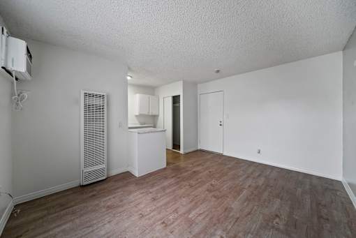 A room with a wooden floor and white walls.