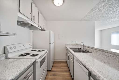 A kitchen with white appliances and cabinets.