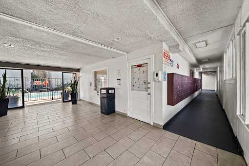 A hallway with a black floor and white walls.