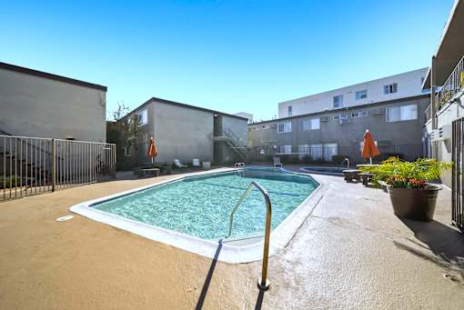 A small pool with a metal fence around it.