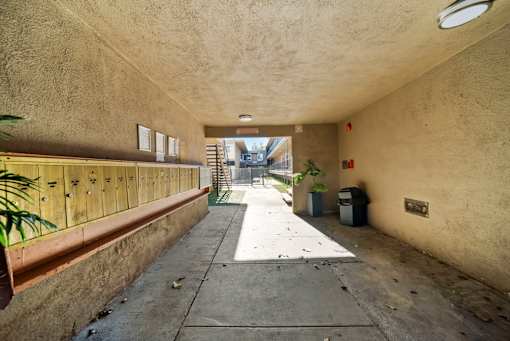 A long, narrow hallway with a concrete floor and walls.